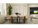 Dining area featuring modern decor, large windows, indoor potted plants, and stylish chairs at 7541 E 116Th St, Palmetto, FL 34221