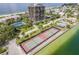 Aerial view of the tennis courts by the water at 7600 Bayshore Dr # 1201A, Treasure Island, FL 33706
