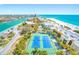 Wonderful aerial view of the beach, tennis courts, and condo community at 7600 Bayshore Dr # 1201A, Treasure Island, FL 33706