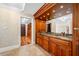 Well-appointed bathroom with granite countertops, custom cabinetry, a sink, and a walk-in closet at 7600 Bayshore Dr # 1201A, Treasure Island, FL 33706
