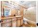 Bathroom features a vanity with granite countertop, custom cabinets, and a glass-enclosed shower at 7600 Bayshore Dr # 1201A, Treasure Island, FL 33706
