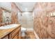 Bathroom showcasing granite vanity, custom cabinets, and a glass-enclosed shower with tile surround at 7600 Bayshore Dr # 1201A, Treasure Island, FL 33706