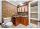 Elegant bathroom featuring wallpaper, a vanity with granite counters, and a closet with shelves at 7600 Bayshore Dr # 1201A, Treasure Island, FL 33706