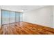 Spacious bedroom features wood floors and floor to ceiling windows with blinds at 7600 Bayshore Dr # 1201A, Treasure Island, FL 33706