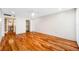 Large bedroom with hardwood floors and neutral walls features a spacious closet and ensuite bathroom at 7600 Bayshore Dr # 1201A, Treasure Island, FL 33706