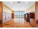 Bright bedroom with wood floors, custom wood paneling, shelving, and large windows overlooking the ocean at 7600 Bayshore Dr # 1201A, Treasure Island, FL 33706