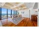 Dining area offers ocean views from large windows, complemented by hardwood floors and classic wall trim at 7600 Bayshore Dr # 1201A, Treasure Island, FL 33706