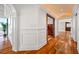 Hallway features beautiful wood floors, detailed trim, and an alcove with floor to ceiling windows at 7600 Bayshore Dr # 1201A, Treasure Island, FL 33706