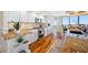 Well-lit kitchen with stainless steel appliances, custom cabinets, granite countertops, and hardwood floors at 7600 Bayshore Dr # 1201A, Treasure Island, FL 33706