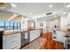 Bright kitchen with white cabinetry, granite counters, hardwood flooring, stainless steel appliances, and a waterfront view at 7600 Bayshore Dr # 1201A, Treasure Island, FL 33706