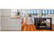 Bright kitchen with white cabinets, granite countertops, hardwood flooring, and modern appliances at 7600 Bayshore Dr # 1201A, Treasure Island, FL 33706