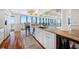 Open-concept kitchen featuring granite countertops, custom cabinets, hardwood floors, and waterfront views at 7600 Bayshore Dr # 1201A, Treasure Island, FL 33706