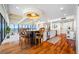 Bright kitchen with white cabinetry, granite counters, hardwood flooring, island seating, and a waterfront view at 7600 Bayshore Dr # 1201A, Treasure Island, FL 33706