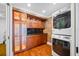 Modern laundry room with wood cabinets, granite countertops, and a stacked washer and dryer at 7600 Bayshore Dr # 1201A, Treasure Island, FL 33706