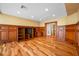 Living room features wood floors and wood paneled walls with built-in cabinets and shelves at 7600 Bayshore Dr # 1201A, Treasure Island, FL 33706
