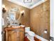 Elegant powder room with floral wallpaper, a stone sink, and unique lighting fixtures at 7600 Bayshore Dr # 1201A, Treasure Island, FL 33706
