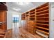 Luxury walk-in closet with custom wood cabinetry, drawers, shelves, and flooring; designed for optimal organization at 7600 Bayshore Dr # 1201A, Treasure Island, FL 33706