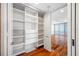 Well-organized walk-in closet with white shelving and drawers, conveniently located next to the bedroom at 7600 Bayshore Dr # 1201A, Treasure Island, FL 33706