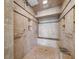 Walk-in shower with decorative tile, a built-in bench, and multiple shower heads for a relaxing experience at 7600 Bayshore Dr # 1201A, Treasure Island, FL 33706