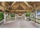 Wooden walkway with tropical foliage leading to the building's entrance, offering an inviting and serene ambiance at 7600 Bayshore Dr # 1201A, Treasure Island, FL 33706