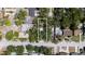 An aerial view of a home and a rectangular lot surrounded by lush green trees and other homes at 8059 26Th N Ave, St Petersburg, FL 33710