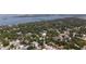 An aerial view of homes among lush greenery and the ocean and land in the distance at 8059 26Th N Ave, St Petersburg, FL 33710