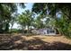 View of a backyard showing the exterior of a house and yard with grass and trees at 8059 26Th N Ave, St Petersburg, FL 33710