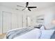 Bright bedroom with a ceiling fan, large closet, and decorative throw blanket on a white bedspread at 8059 26Th N Ave, St Petersburg, FL 33710