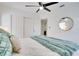 Spacious bedroom with plush bedding, overhead fan, closet and connecting ensuite bathroom at 8059 26Th N Ave, St Petersburg, FL 33710
