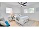 Well-lit bedroom with natural light, overhead fan, side table, and plush bed at 8059 26Th N Ave, St Petersburg, FL 33710