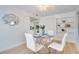 Bright dining area features a round glass table, white chairs, and built-in display shelving at 8059 26Th N Ave, St Petersburg, FL 33710
