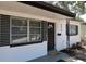 Charming home featuring a black garage door, complemented by white paint, black trim and a well-manicured lawn at 8059 26Th N Ave, St Petersburg, FL 33710