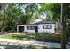 Inviting single-story home has a modern aesthetic with black trim, fresh landscaping, and an attached garage at 8059 26Th N Ave, St Petersburg, FL 33710