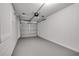 Empty, single car garage with a white door and painted walls with sealed concrete floor at 8059 26Th N Ave, St Petersburg, FL 33710