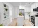 Modern kitchen features stainless steel appliances, white cabinetry, and an island for added workspace at 8059 26Th N Ave, St Petersburg, FL 33710