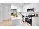 Well-appointed kitchen with white cabinets, stainless steel appliances, and a center island at 8059 26Th N Ave, St Petersburg, FL 33710