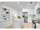 Bright kitchen features white cabinetry, stainless appliances, and center island with quartz countertop at 8059 26Th N Ave, St Petersburg, FL 33710