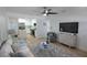 Bright living room featuring modern furnishings, a ceiling fan, and an open view to the kitchen at 8059 26Th N Ave, St Petersburg, FL 33710