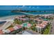 Breathtaking aerial view of beachfront condos, pool, and ocean-side bridge offering a luxurious coastal lifestyle at 865 S Gulfview Blvd # 202, Clearwater Beach, FL 33767