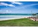 Beautiful backyard with lush lawn, beachfront access, and patio area for outdoor dining and relaxation at 865 S Gulfview Blvd # 202, Clearwater Beach, FL 33767