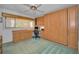 Bedroom featuring built-in wall cabinets and desk space with verdant green carpet at 865 S Gulfview Blvd # 202, Clearwater Beach, FL 33767