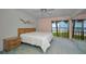 Bright bedroom with a serene waterfront view, a King bed, and mirrored closet at 865 S Gulfview Blvd # 202, Clearwater Beach, FL 33767