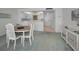 Dining area adjacent to the kitchen with modern white cabinetry and ample counter space at 865 S Gulfview Blvd # 202, Clearwater Beach, FL 33767