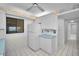 Clean eat-in kitchen with white appliances and tile flooring in a vintage beach condo at 865 S Gulfview Blvd # 202, Clearwater Beach, FL 33767