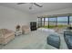 Bright living room with a view of the beach from the enclosed patio and comfortable seating at 865 S Gulfview Blvd # 202, Clearwater Beach, FL 33767