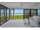 Relaxing enclosed patio with stunning ocean views, tile flooring and comfortable seating area to enjoy the outdoors at 865 S Gulfview Blvd # 202, Clearwater Beach, FL 33767