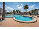 Relax in this community pool with palm trees and plenty of lounge seating at 865 S Gulfview Blvd # 202, Clearwater Beach, FL 33767
