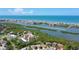 Breathtaking aerial view of the waterfront community on the Gulf Coast, surrounded by lush green foliage and blue waters at 9000 Commodore Dr # 606, Seminole, FL 33776