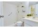 Bright bathroom featuring a walk-in shower with tiled walls, grab bar, and decorative accents at 9000 Commodore Dr # 606, Seminole, FL 33776
