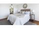 Bedroom with two side tables, plush bedding, comfortable queen size bed and water views at 9000 Commodore Dr # 606, Seminole, FL 33776